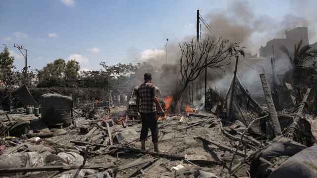 Palestinians inspect the scene after an Israeli raid on the tents of displaced people in the Al-Mawasi area of Khan Yunis in the southern Gaza Strip, 13 July 2024